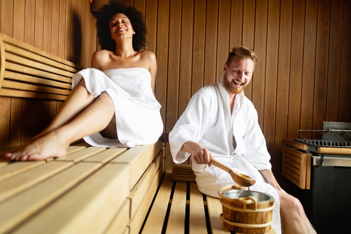 Couple relaxing, resting and sweating in sauna